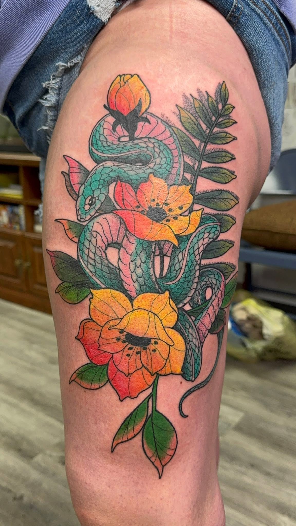 Snake and flowers color tattoo, thigh piece
